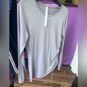 NWT- Lululemon gray/mauve”moonwalk” long sleeve top with side drawstring, sz 8